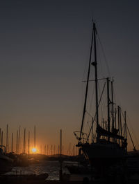 Sailboats in marina at sunset