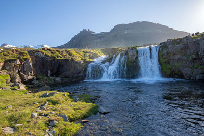 Scenic view of waterfall against clear sky