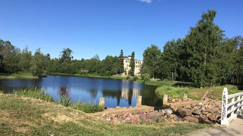 Scenic view of lake against clear blue sky