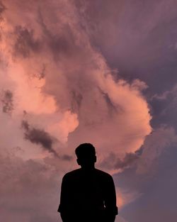 Silhouette man standing against sky during sunset