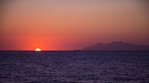 Scenic view of sea against orange sky