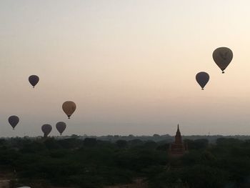 Hot air balloons in sky at sunset