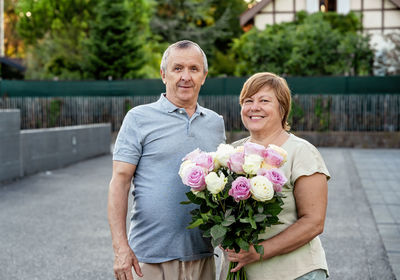 Portrait of smiling couple standing outdoors