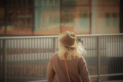 Rear view of woman standing on a bridge