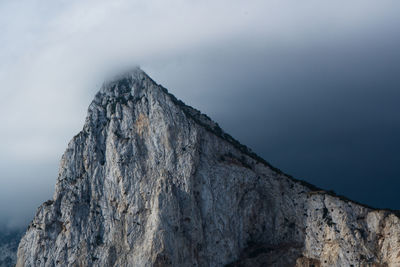 Low angle view of rock formation against sky