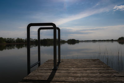 Pier over lake against sky