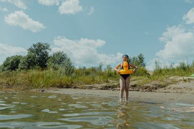 Low section of man standing in water