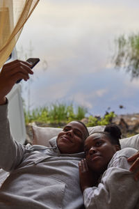 Young couple taking selfie in camper van