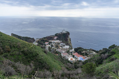 High angle view of buildings by sea against sky