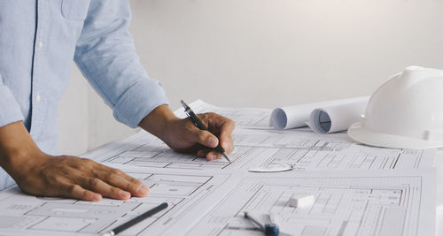 Midsection of man working on table