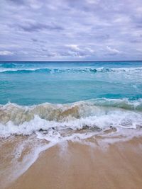 Scenic view of sea against cloudy sky