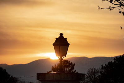 Low angle view of street lamp during sunset