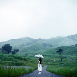 Full length of woman standing on grassy field