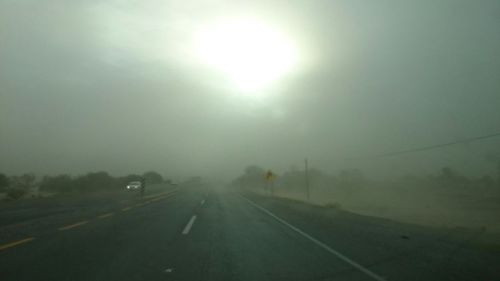 Road passing through foggy weather