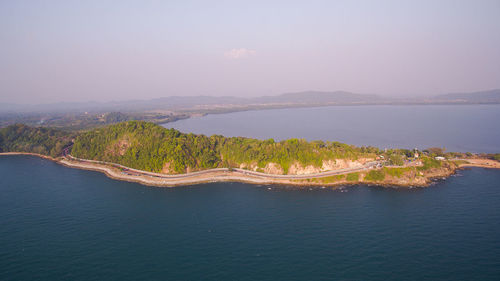 High angle view of sea and mountains against sky