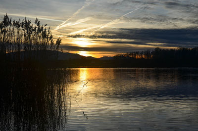 Scenic view of lake at sunset