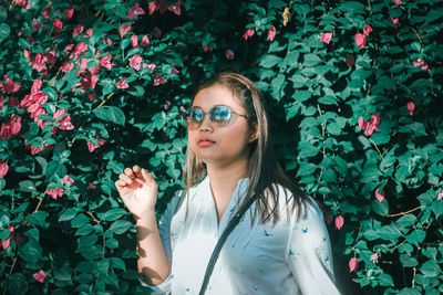 Portrait of beautiful woman with red flower