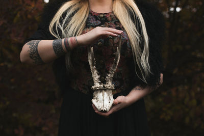 Close up lady handling animal skull concept photo