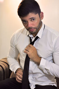 Portrait of young man sitting at home