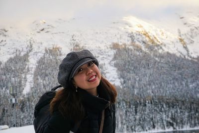 Portrait of smiling young woman in snow