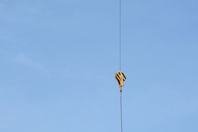 Low angle view of street light against blue sky