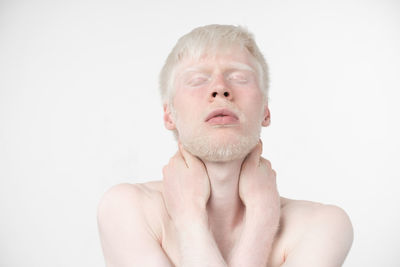 Portrait of shirtless man against white background