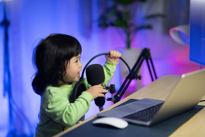 Close-up of of girl singing at studio