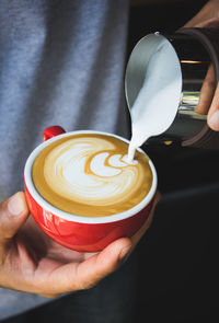 Cropped image of person holding coffee cup