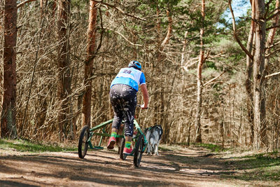 Rear view of man riding bicycle