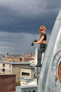 Full length of man standing by building against sky