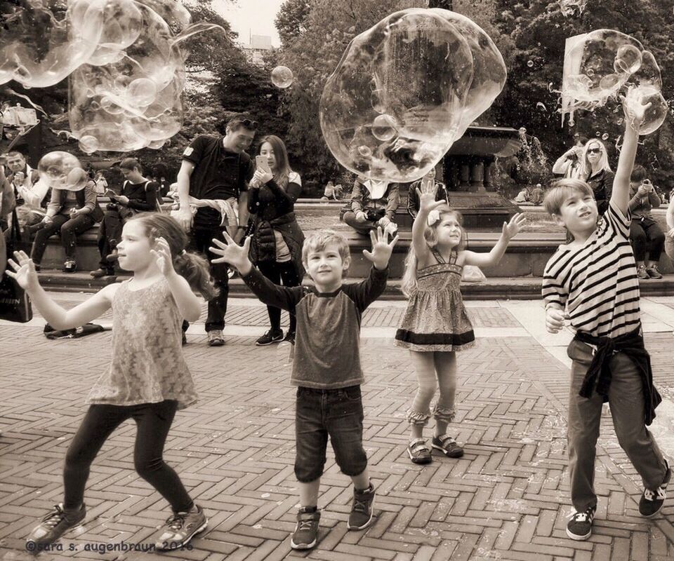 lifestyles, large group of people, leisure activity, men, casual clothing, full length, person, street, standing, arts culture and entertainment, walking, togetherness, medium group of people, outdoors, enjoyment, celebration, sunlight, day, cultures