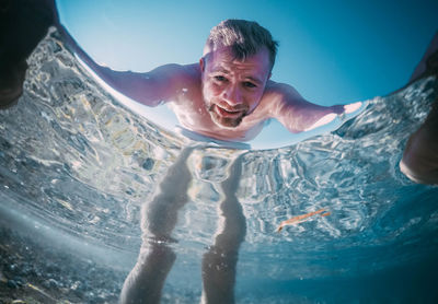 Portrait of man swimming in pool