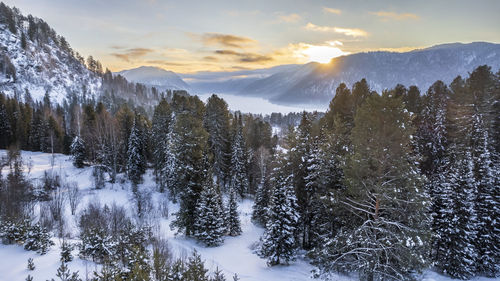 Panoramic view of snow covered mountains against sky during sunset