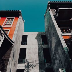 Low angle view of residential buildings against blue sky