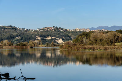 Scenic view of lake by trees against clear sky