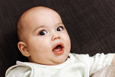 Close-up of baby lying on bed