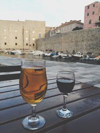 View of wine in glass on table in front of city