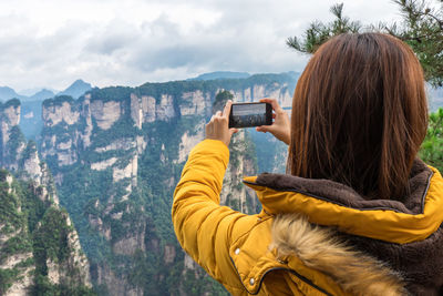 Rear view of person photographing