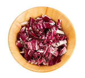 Directly above shot of chopped fruits in bowl against white background