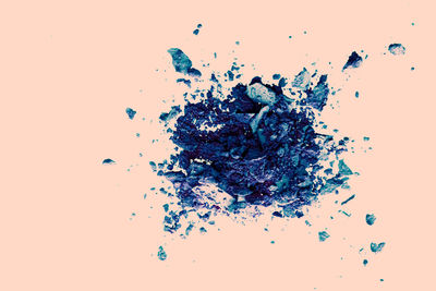 Directly above shot of broken glass against white background