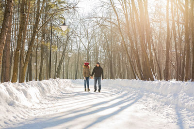 Full length of man walking on snow covered land