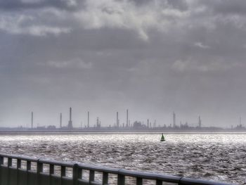 Sailboats in sea against sky