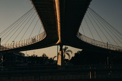 Low angle view of suspension bridge against sky