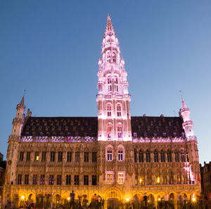 Low angle view of illuminated building against sky at night