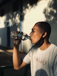 Young man drinking beer glass bottle