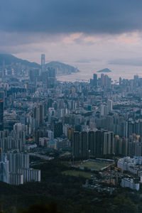 Aerial view of buildings in city against sky