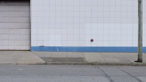 Street light on footpath against building
