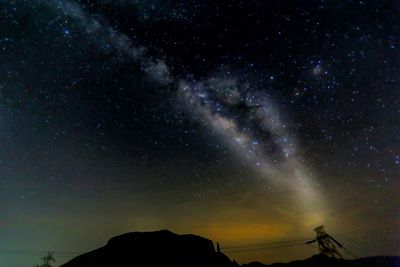 Low angle view of silhouette mountain against star field