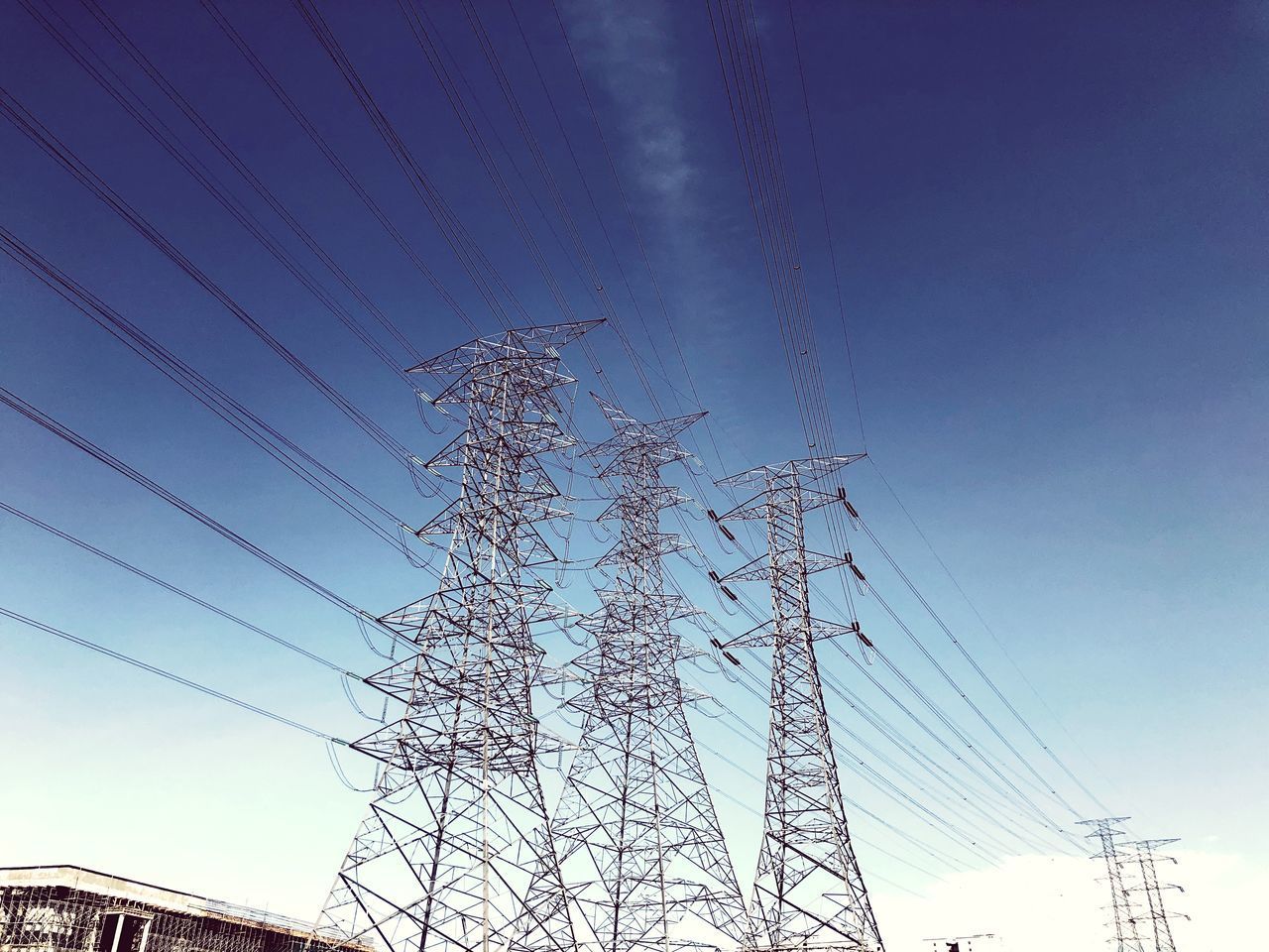 LOW ANGLE VIEW OF POWER LINES AGAINST BLUE SKY