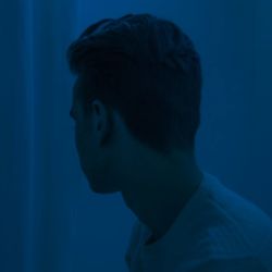 Close-up of man against blue background